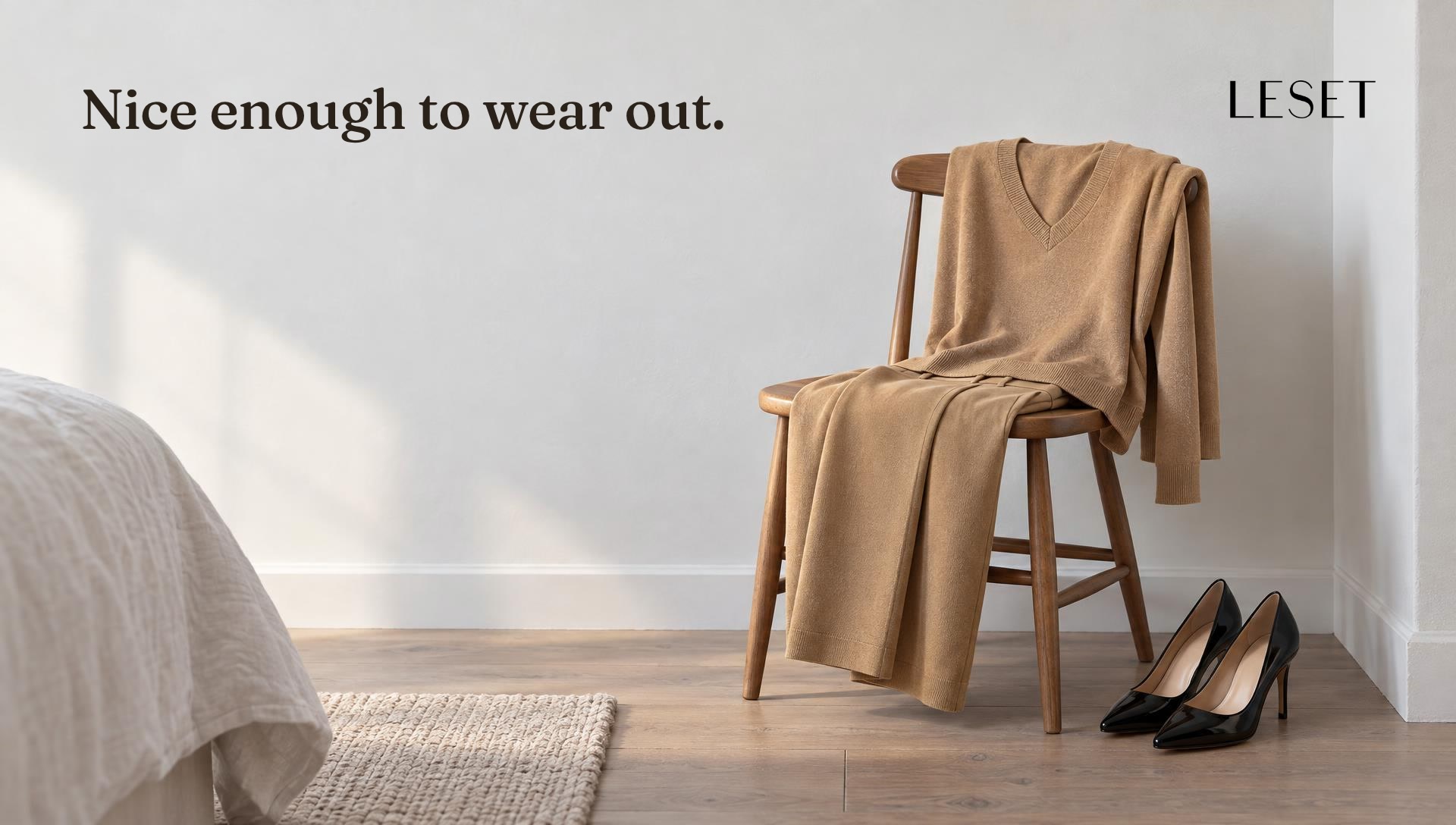A camel knit set over a chair beside evening heels at dawn